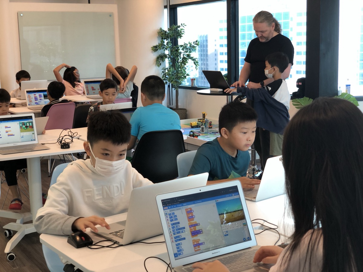 Older LCCL students focused on writing code on their laptops